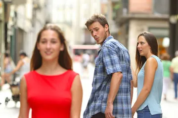 guy holding hand with girl and looks back