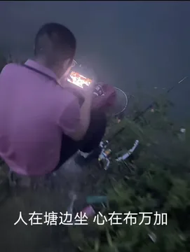 人在塘边坐 心在布万加 男子坐池塘边钓鱼玩着DNF搞笑图