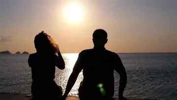 A Boy And Girl On A Sandy Beach